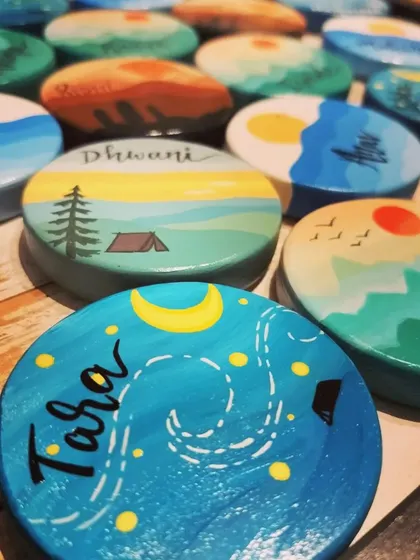 A duplicate of 59, an assortment of our travel-themed magnets, showing the variety of scenes we can create, including starry nights over a campsite and sunsets over the forest.
