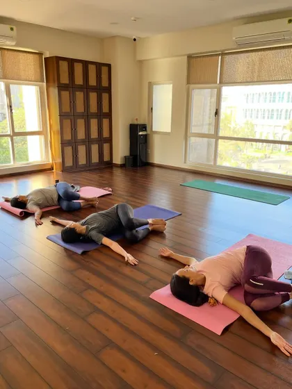 Embrace the art of untwisting and unraveling. A student rests in a gentle spinal twist, creating space and balance.
