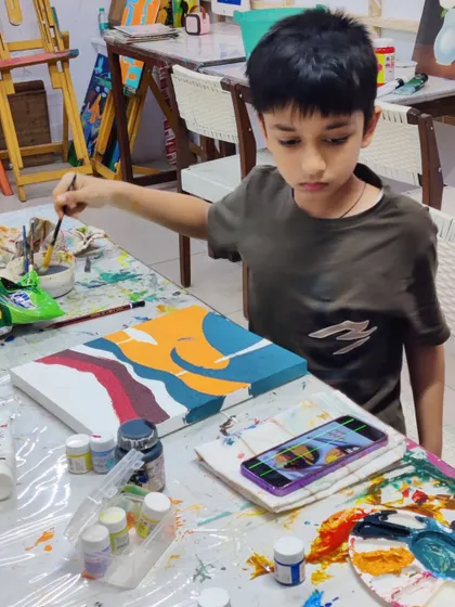 Scenes from our kids' acrylic workshop, where students learn to create bold and colorful landscape paintings.