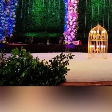 Decorative props like this illuminated golden birdcage add a touch of whimsy and elegance to the stage design. These small details help complete the overall theme and provide beautiful photo opportunities.