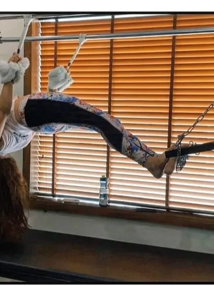 This inverted hanging exercise on the Cadillac helps to lengthen the spine and strengthen the entire posterior chain. It's an advanced move that demonstrates incredible body control.