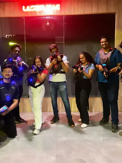 A large group of friends ready for an epic laser tag game.