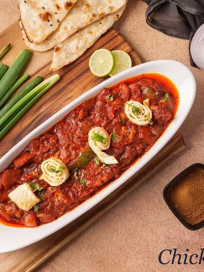 Chicken Lapeta is a thick, semi-dry gravy dish where tender chicken pieces are "wrapped" (lapeta) in a spicy masala. It's garnished with swirls of egg omelette for added richness.
