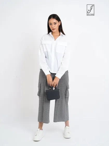 A standard e-commerce pose, showing the full outfit from the front with a small handbag as an accessory.
