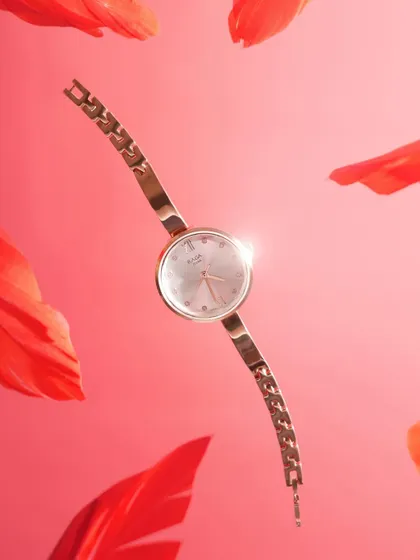 Time, redefined with grace. This final shot captures the Titan Raga watch appearing to float weightlessly among red petals, a perfect blend of artistry and precision.