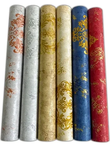 A lineup of six wallpaper rolls showing a damask pattern in various colors, including orange, silver, gold, blue, and red.