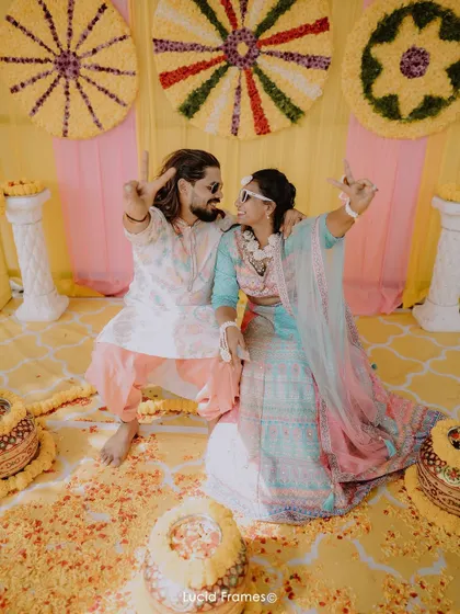 A fun and quirky pose from the couple at their colorful Haldi ceremony.