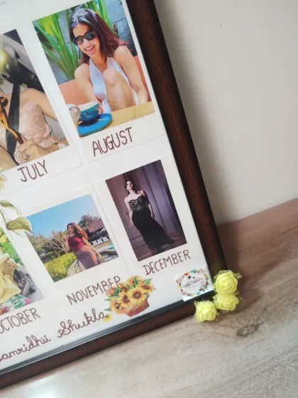 A close-up of the custom calendar frame, showing the detailed monthly photo layout and hand-drawn titles. I can customize the theme and style to fit any request.