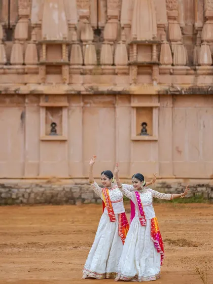 The flow and grace of Kathak in a simple, elegant pose. The architecture of the temple provides a stunning, timeless background for our classical dance form.