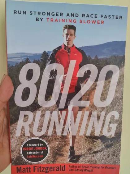 This book, '80/20 Running', is a cornerstone of my coaching philosophy. I believe that most of your weekly mileage should be at a low to moderate intensity, which builds a powerful aerobic engine and reduces the risk of burnout and injury.