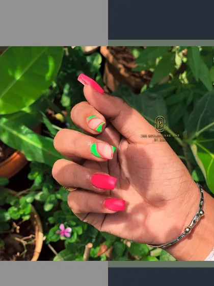 Make a statement with these vibrant neon nails. The combination of hot pink and electric green in an abstract design is guaranteed to turn heads.