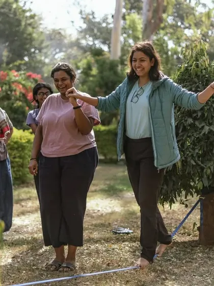 Women helping women, whether it's learning to slackline or belay a rope. This spirit of mutual support is the foundation of our community.