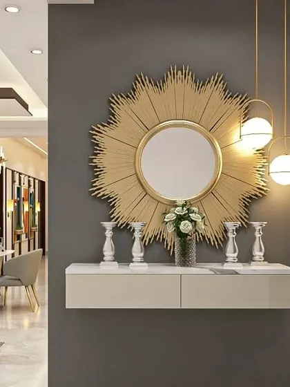 A glamorous foyer with a large, sunburst-shaped mirror that makes a bold statement. The floating white console and modern pendant lights complete the chic and sophisticated look.