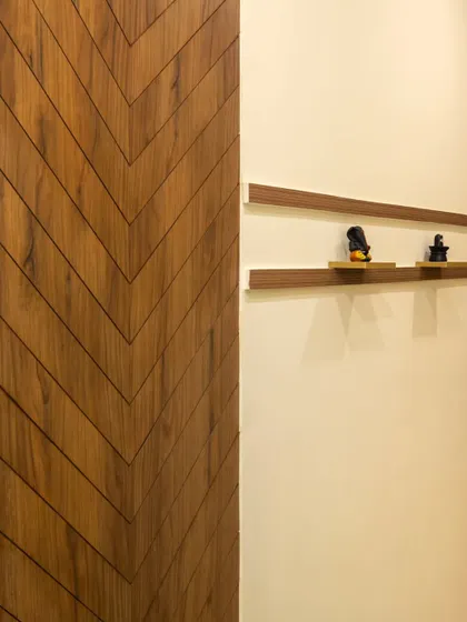 A hidden door with a chevron wood pattern, designed to blend seamlessly with the wall for a clean, minimalist look.