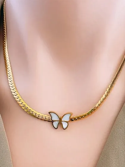 A beautiful butterfly necklace with a mother-of-pearl inlay on a gold-toned snake chain. This piece is crafted from high-quality materials for lasting beauty.