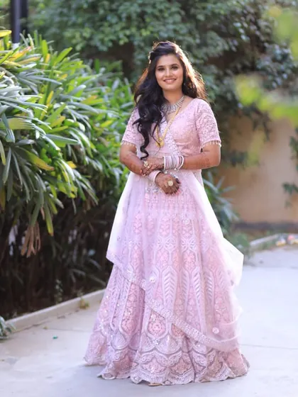 A vision of grace for her engagement day. This intricately detailed pink lehenga is a stunning choice for a bride who wants a blend of tradition and modernity.
