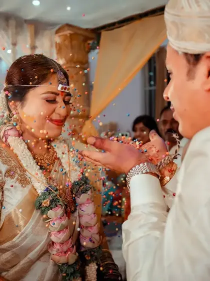 A candid shot capturing the joy and emotion of the talambralu ceremony, a significant and beautiful part of many South Indian weddings.