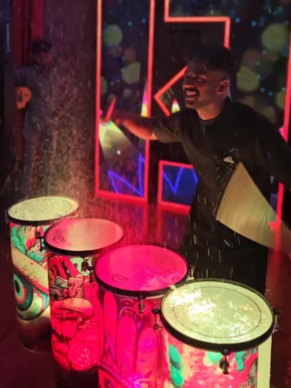 The liquid drummer is all smiles while performing. The energy is infectious, and it spreads from the stage right into the crowd.