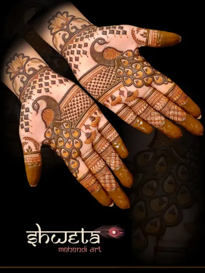 A stylish peacock design on the back of the hands. The cutwork technique creates a lovely contrast and gives the design a modern, edgy feel.