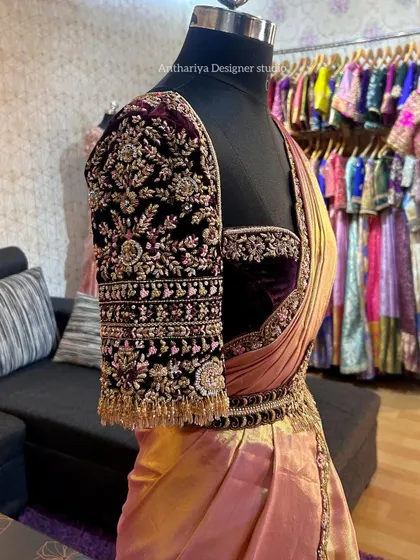 The sleeve of the velvet blouse, a work of art in itself with dense floral and traditional motifs.