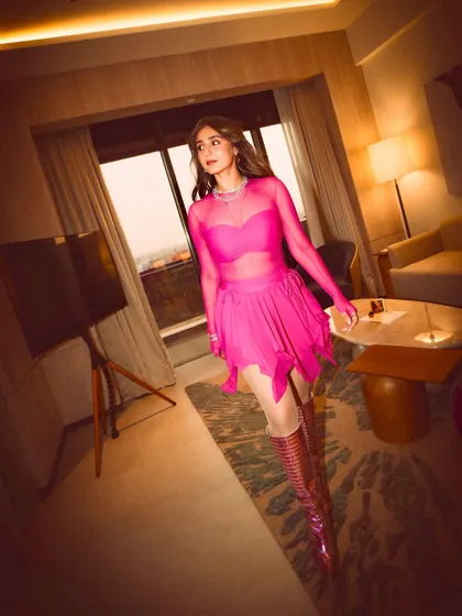 The full head-to-toe look. The metallic pink boots are the perfect edgy complement to the soft, sheer dress.
