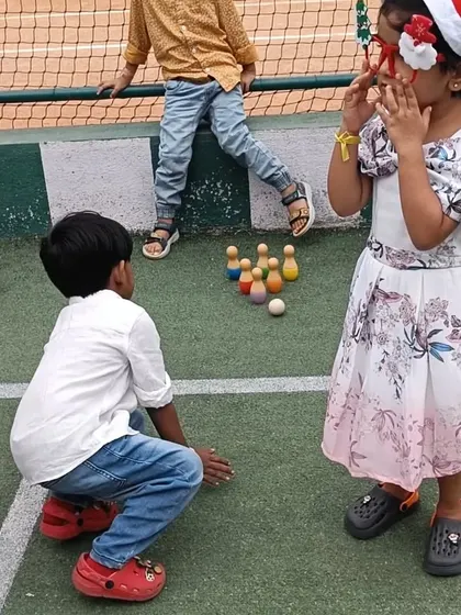 A game of bowling at our Christmas carnival. Play is serious work for children, and these games help develop coordination and concentration.