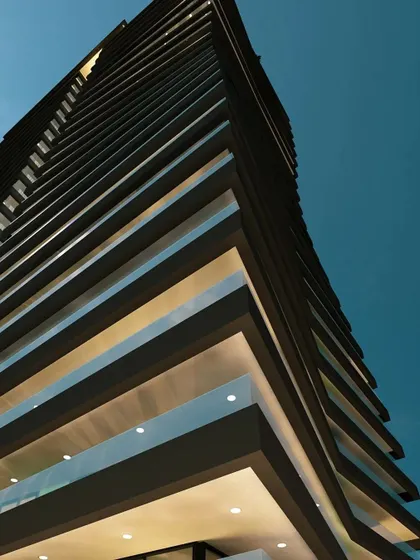A detail shot looking up at the Embrace Tower's facade. The rhythmic pattern of the balconies and the clean, straight lines of the interior structure create a powerful architectural statement.