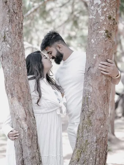 An intimate close-up of a couple amidst the trees in Ooty, capturing a quiet and romantic moment.