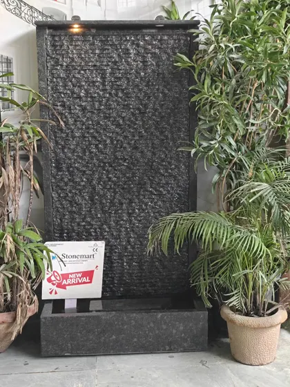 The granite waterfall shown in an indoor setting, demonstrating its versatility. It requires no special plumbing, just a power source.