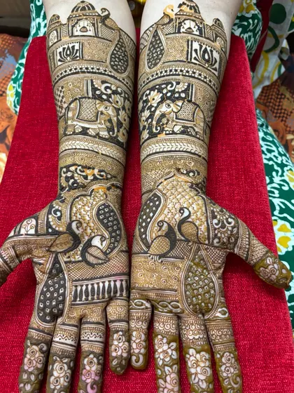 Full coverage bridal henna with beautiful peacocks and elephants. These animals are symbols of grace and strength, perfect for a bride's new beginning.