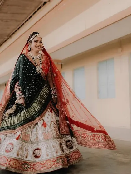 A full-length shot capturing the bride's happiness and the flow of her beautiful lehenga. The makeup is designed to look stunning both up close and from a distance.