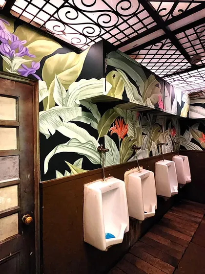 The men's section of the washroom at The Drunken Botanist, where the beautiful botanical theme continues. We ensure our designs are consistent and high-quality throughout a space.