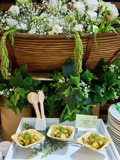 Our Chutneywale Aloo served in eco-friendly bowls against a backdrop of lush greenery. This setup highlights our commitment to both flavour and sustainable presentation.