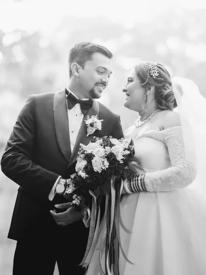 A classic black and white portrait of the couple after their ceremony. The soft outdoor light and their happy expressions make for a perfect wedding photo.