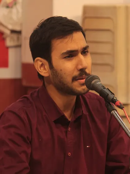 A student presenting his devotional song with focus and sincerity.