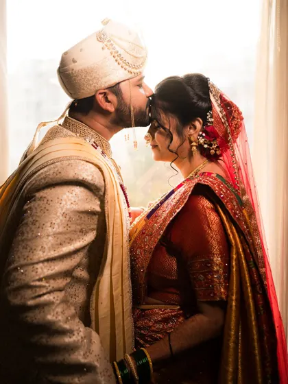 A gentle kiss, a silent promise. Somila and Abhishek's wedding portrait is filled with traditional elegance and soft, romantic light.