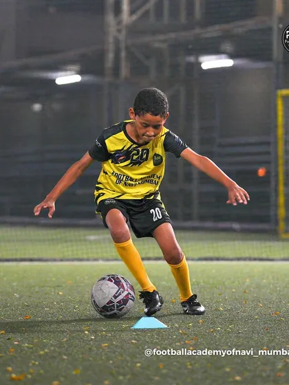 A young player dribbles through a cone drill, showing the focus and determination I expect from my athletes.