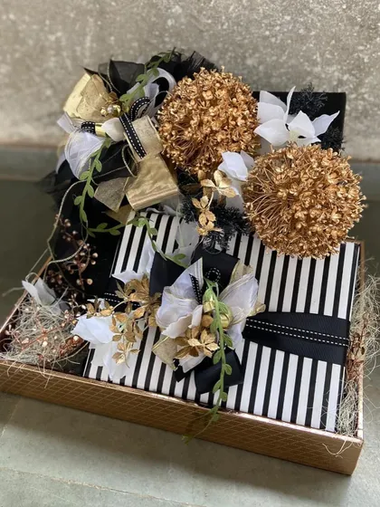 Modern and chic, this black and white striped hamper is accented with gold and white floral details. It’s a contemporary take on luxury gifting, ideal for corporate clients or anyone with a flair for bold design.