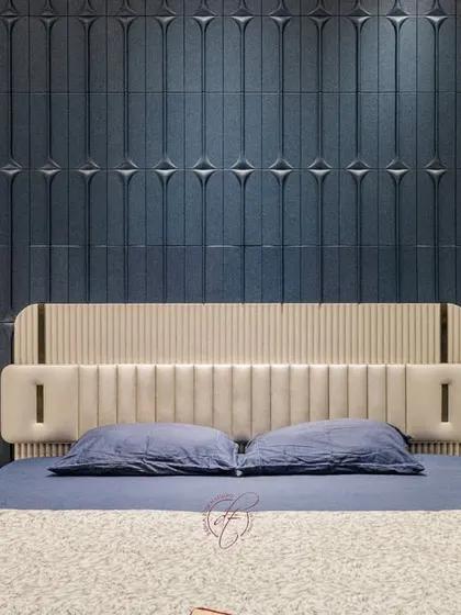 A close-up of the custom-designed headboard and the intricate 3D paneling on the accent wall. This detail shot showcases our commitment to craftsmanship and high-quality finishes.