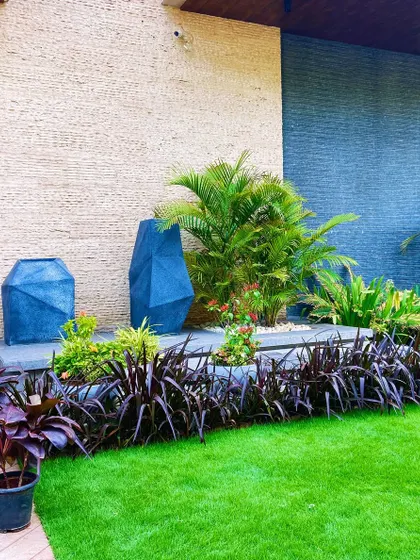 A wider view of the Faridabad entrance, showing how the lawn and layered planting create a welcoming and impressive approach to the home.