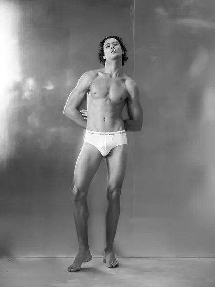A minimalist, black and white shot inspired by classic Calvin Klein campaigns. The styling is stripped back to essentials, focusing on the male form and an attitude of athletic confidence.