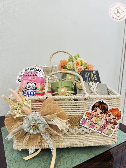 A rustic and charming Rakhi hamper in a handcrafted jute basket. This gift is packed with love, treats, and thoughtful details like a large burlap bow and cute stickers to make your sibling's day.