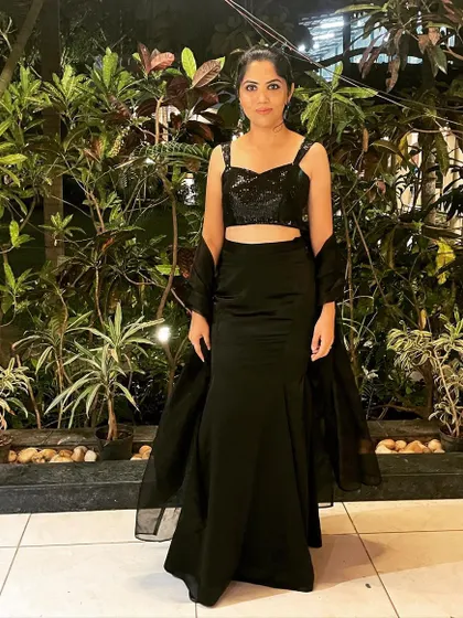 This client is ready for her cocktail event in a custom all-black outfit. The sparkling sequins on the crop top contrast with the smooth satin of the skirt, creating a look that is both elegant and modern.