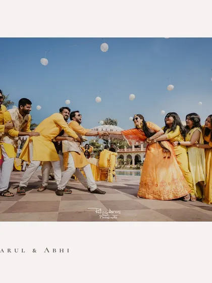 The classic wedding tug-of-war! A fun-filled moment between the bride's side and the groom's side during the Haldi festivities, full of laughter and friendly competition.