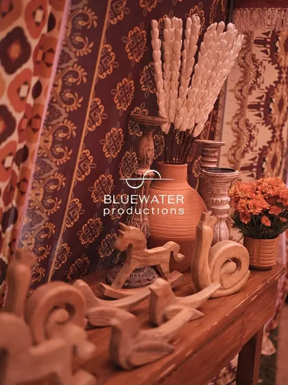 A shelf styled with wooden toys and dried flowers, adding to the market-like feel.