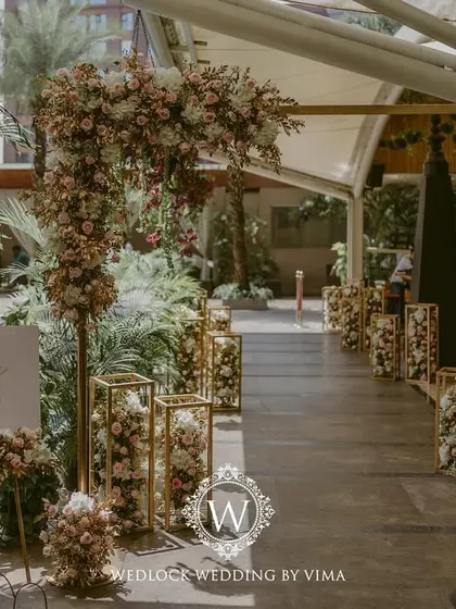 For this Punjabi wedding, we designed a subtle and elegant poolside mandap. The decor featured light fabrics, soft peachy-pink florals, and hints of gold to complement the serene setting.