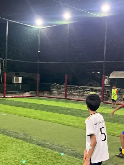 A focused bowler gets ready to deliver the ball during a thrilling night match. The energy is always high at our parties.