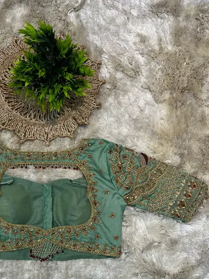 Another view of the back of the pastel green blouse, emphasizing the beautiful craftsmanship.