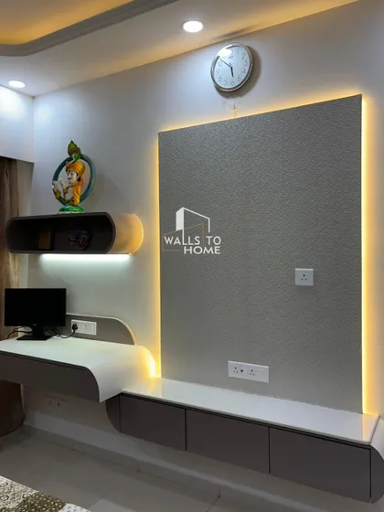 This custom unit combines a TV console with a sleek, curved study table. The design is space-efficient and features integrated backlighting, making it both a functional workspace and an entertainment hub.