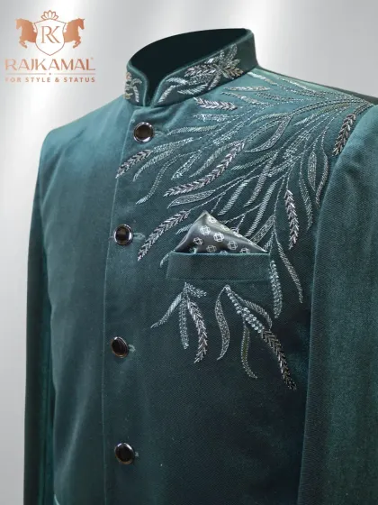 A closer look at the leaf-patterned silver embroidery on the shoulder of the green velvet Jodhpuri.